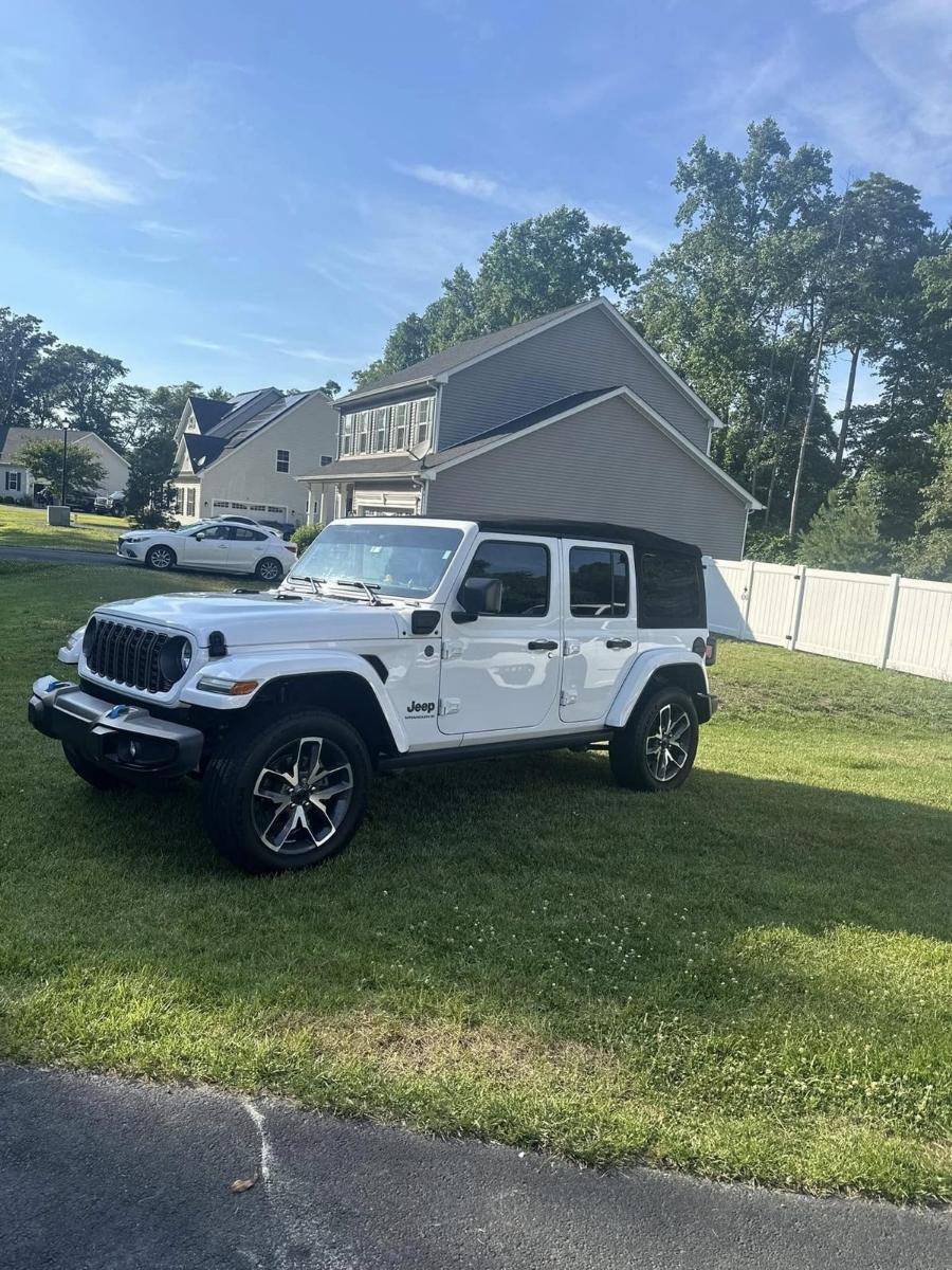 Detailed white Jeep Wrangler on a customer driveway